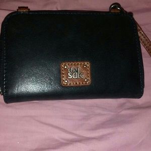 A new brown and black The Sak body purse